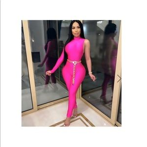 Pink jumpsuit with gold chain belt